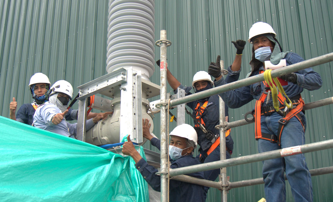Five employees working at heights at a compression station.