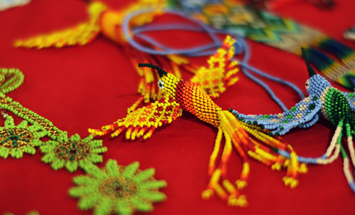 Colorful handicraft jewelry with bird-shaped trinkets.
